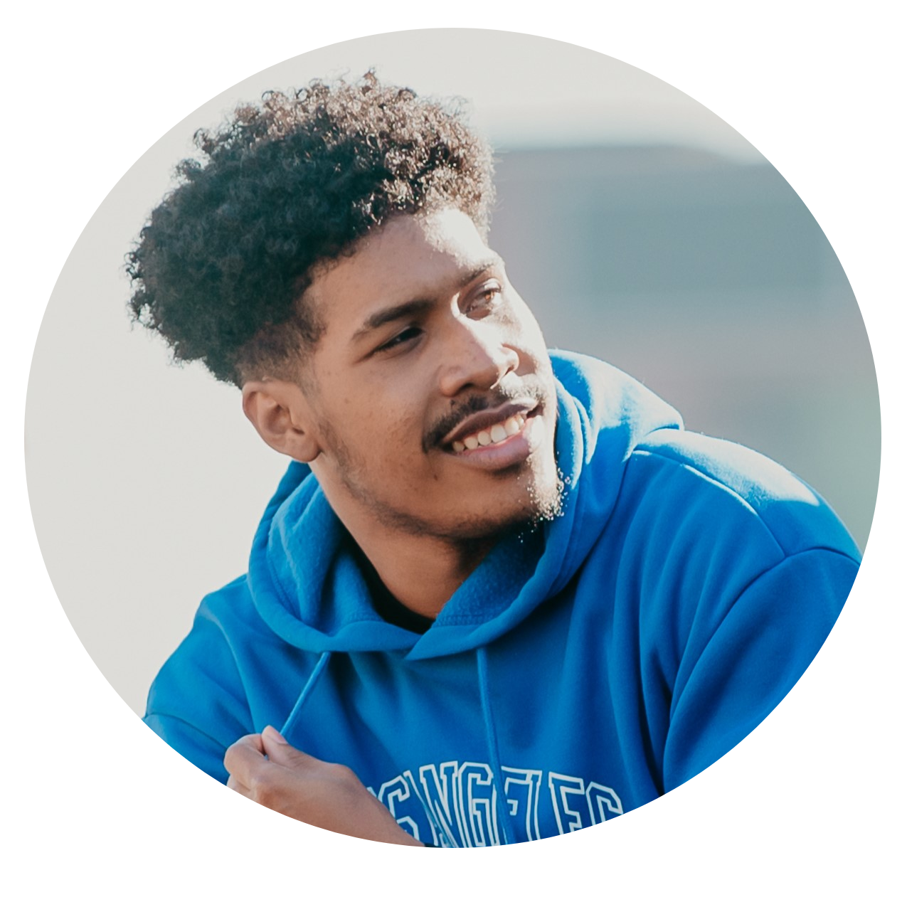 Fabrice Elono smiling in blue hoodie